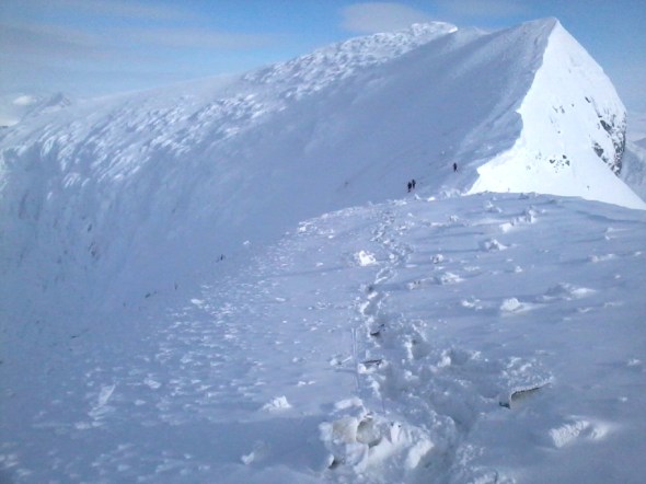 Pieces from the transport aircraft partly covered covered in snow near down to the right in this photo (photo: Norwegian Special Forces, FSK, HJK, MJK) 