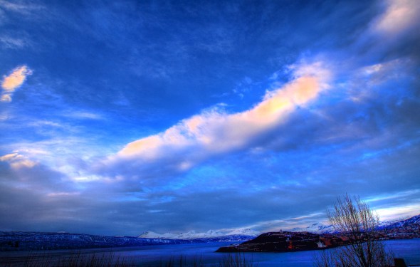 HDR of the Narvik peninsula, the surrounding fjords and mountains underneath a sky with intermittent clouds